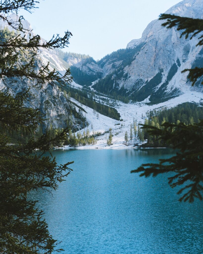 A tranquil mountain lake amidst a lush forest and majestic peaks, perfect for nature lovers and adventure seekers.