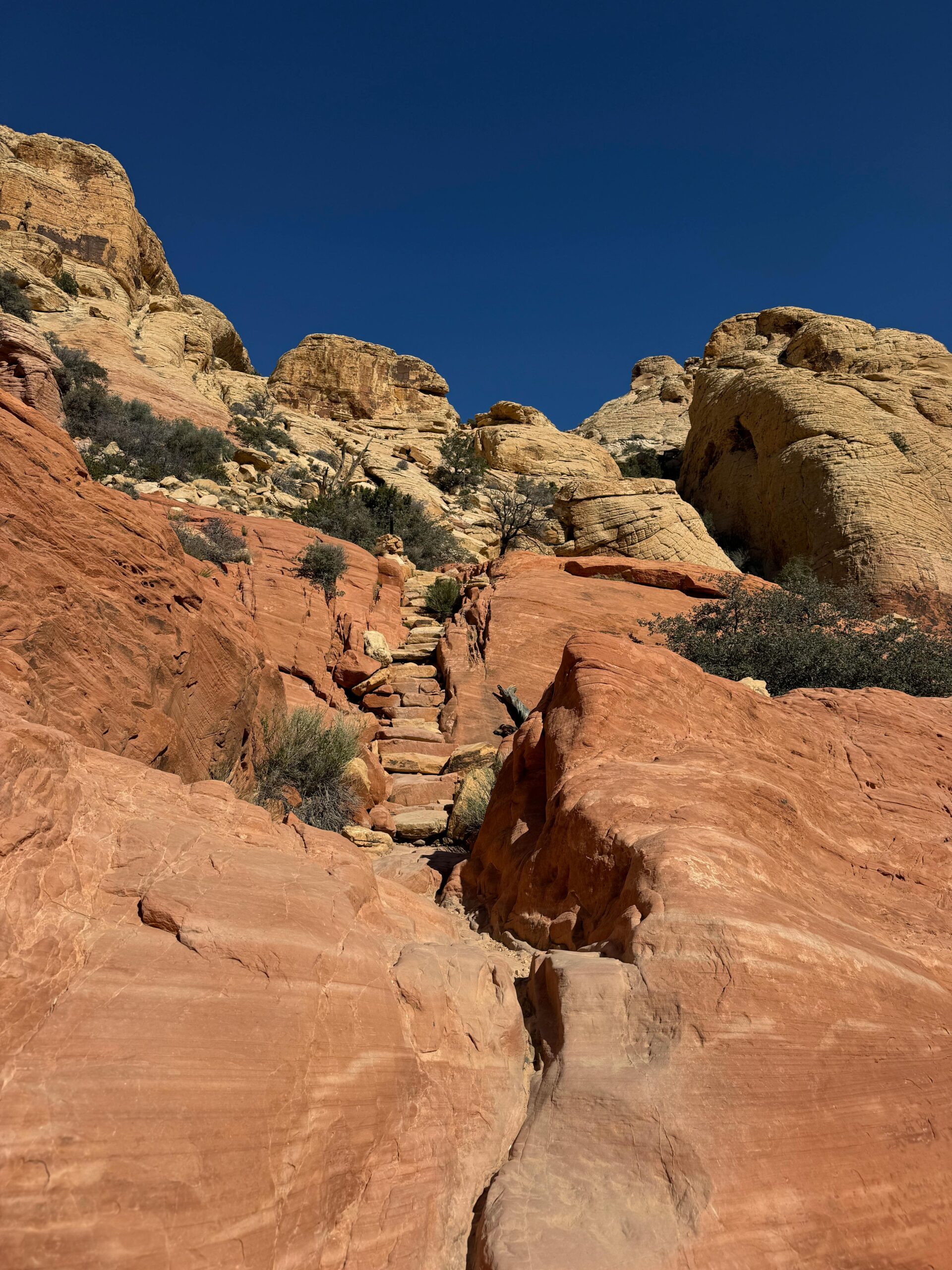 Vivid red rock formations under clear blue sky in Nevada's Red Rock Canyon.